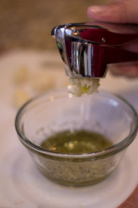 Adding Crushed Garlic to the Rosemary and Olive Oil