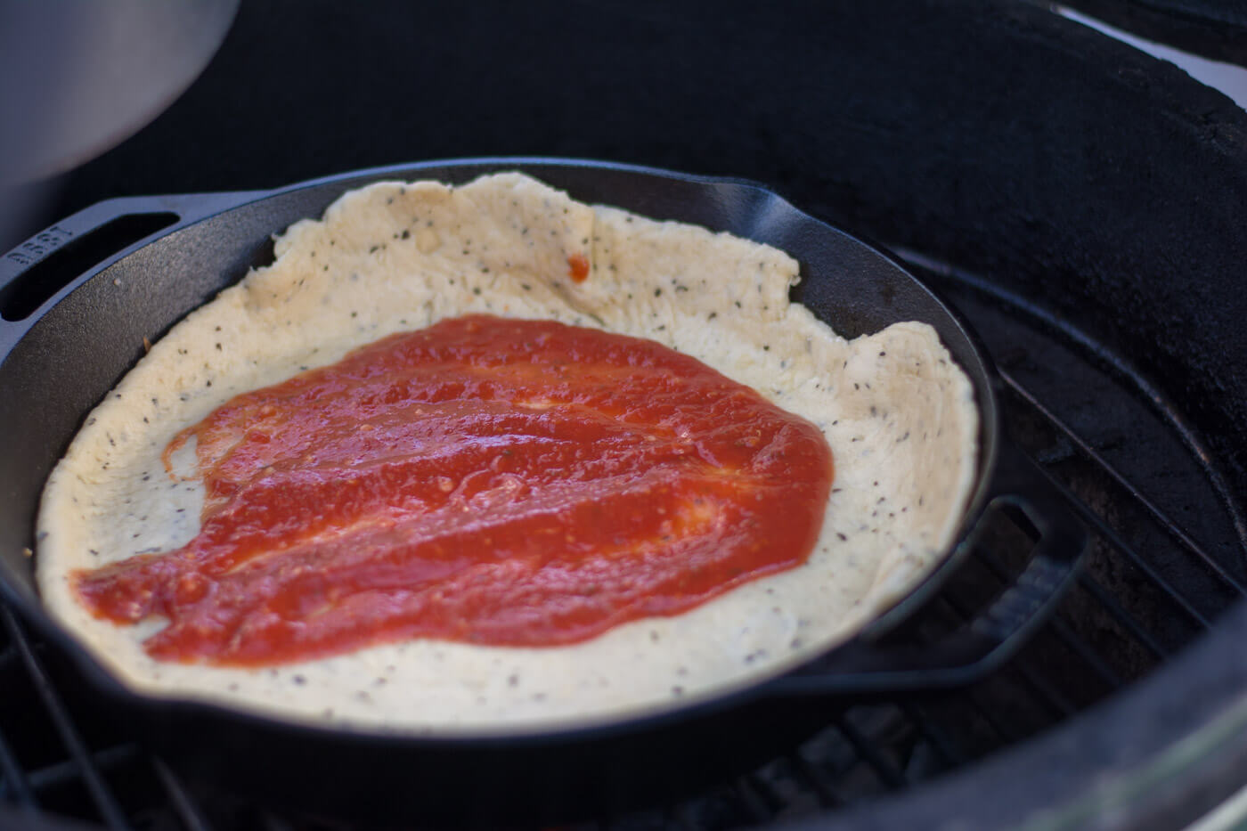 Adding Sauce for Grilled Cast Iron Skillet Pizza