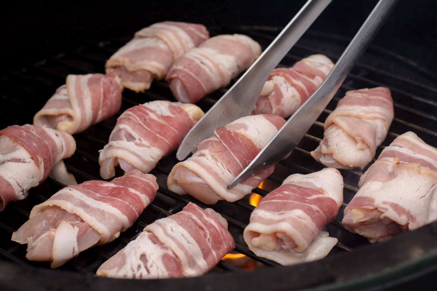 Adding the Bacon Wrapped Chicken Bites to the grill.