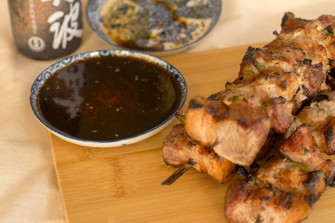 Pork Belly Yakitori and Dipping Sauce on a Cutting Board