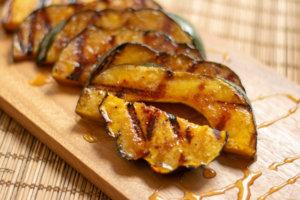Drizzled Honey over the fully cooked acorn squash on the cutting board
