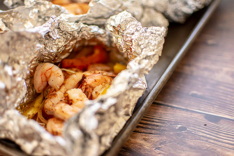 Grilled Foil Pack Shrimp on a sheet pan and ready for eating