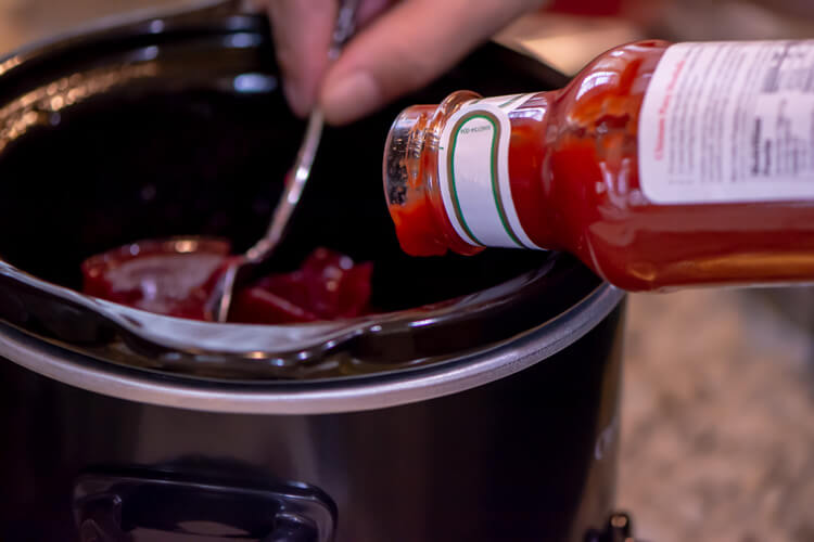Add a bottle of chili sauce and a can of cranberry to a slow cooker and turn on low
