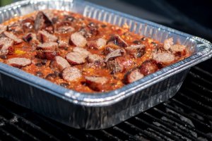 Use a large disposable pan on the grill to cook the chili with the beer brats. The pan is doubled up just in case of a spill.