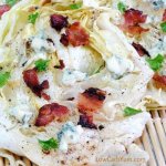 Grilled Slice of Cabbage and coated with blue cheese and chunks of bacon
