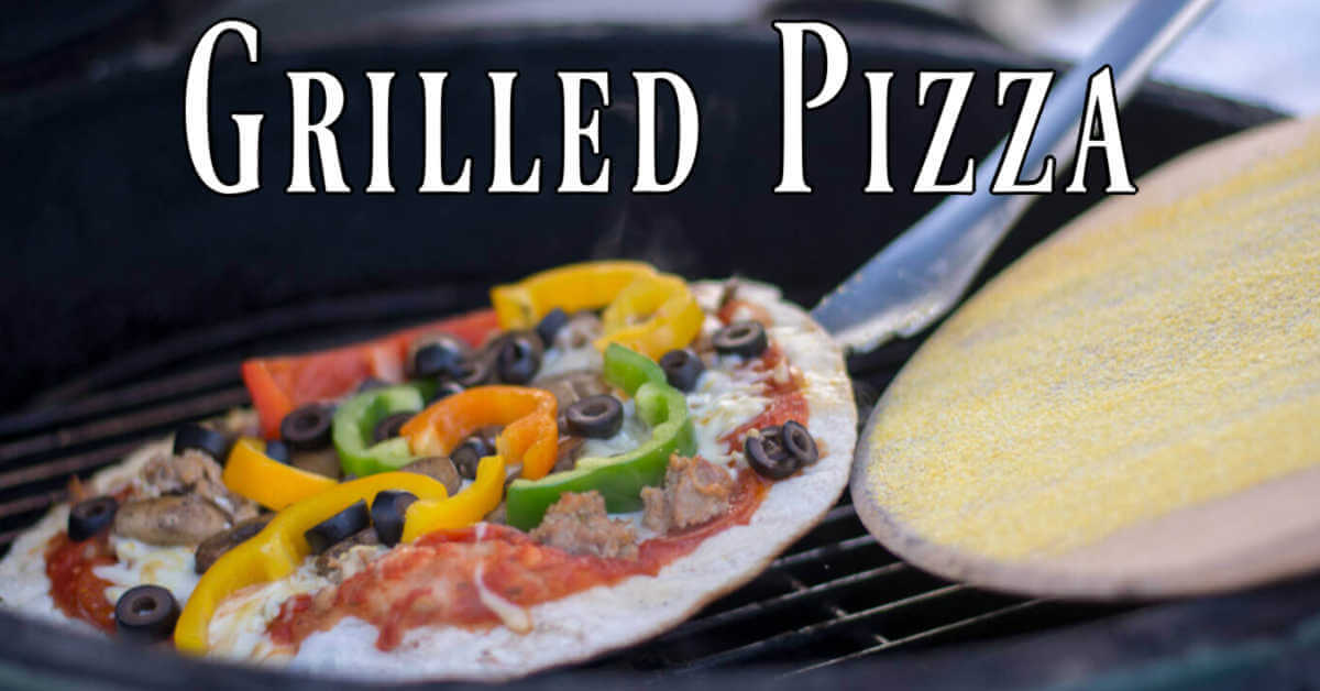 grilled pizza being removed from the grate with a pizza peel