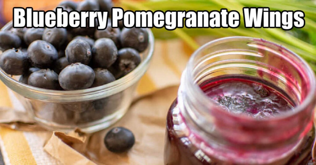 fresh blueberries in a bowl with a jar of the pomegranate BBQ sauce