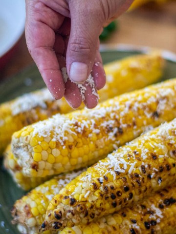 sprinkling on aged Cotija cheese on the grilled beer corn.