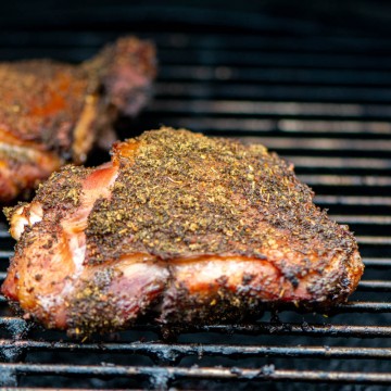 smoked thigh on the grill covered in poultry seasoning