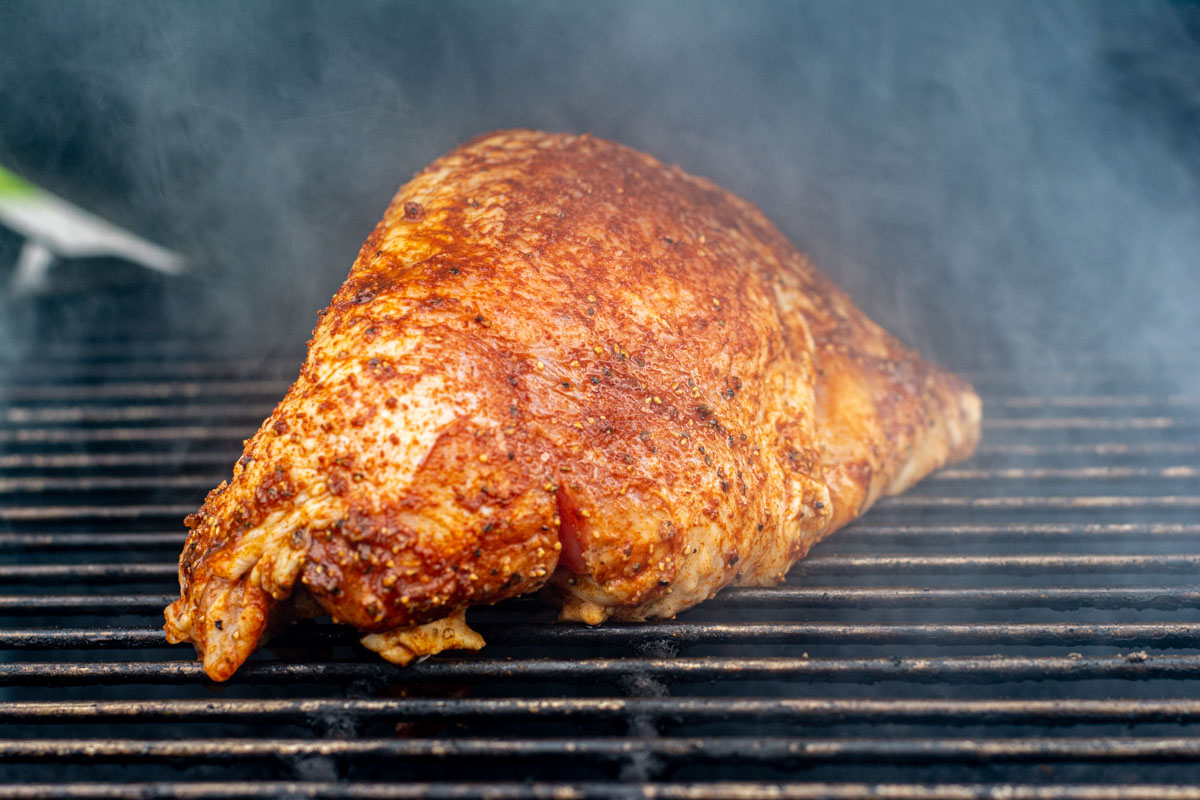 turkey breast on the grill being smoked