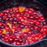 cranberries and clementines breaking down in the cast iron over the open flame of the grill.