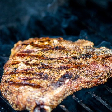t bone steak on a grillgrate with gorgeous sear marks.