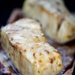 two filets of sea bass on a cedar plank on the grill with a light bourbon glaze.