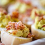 deviled egg and crumbled bacon on a sheet pan.