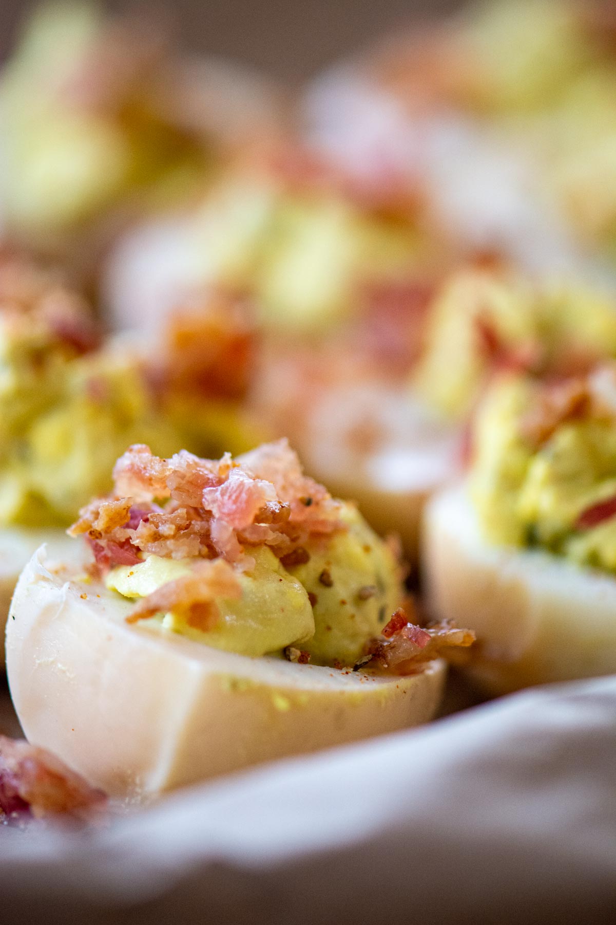 deviled egg and crumbled bacon on a sheet pan.