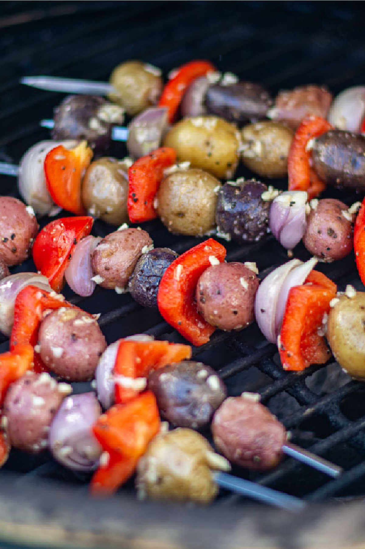 potatoes, shallots and red peppers on kabobs and coated with a garlic mixture on the grill.