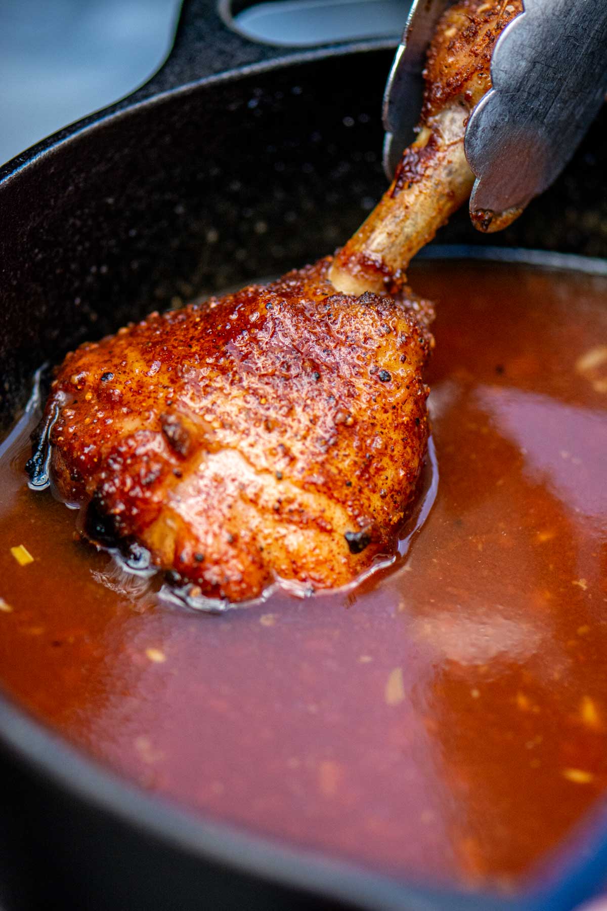 Dipping the chicken lollipop into the homemade sweet BBQ sauce.