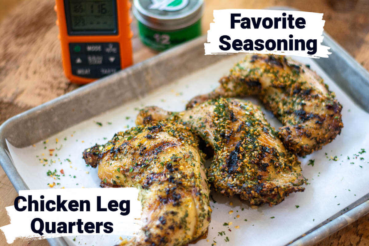 ingredient photo showing grilled chicken legs on a sheet pan in front of a wireless thermometer and a jar of seasoning.