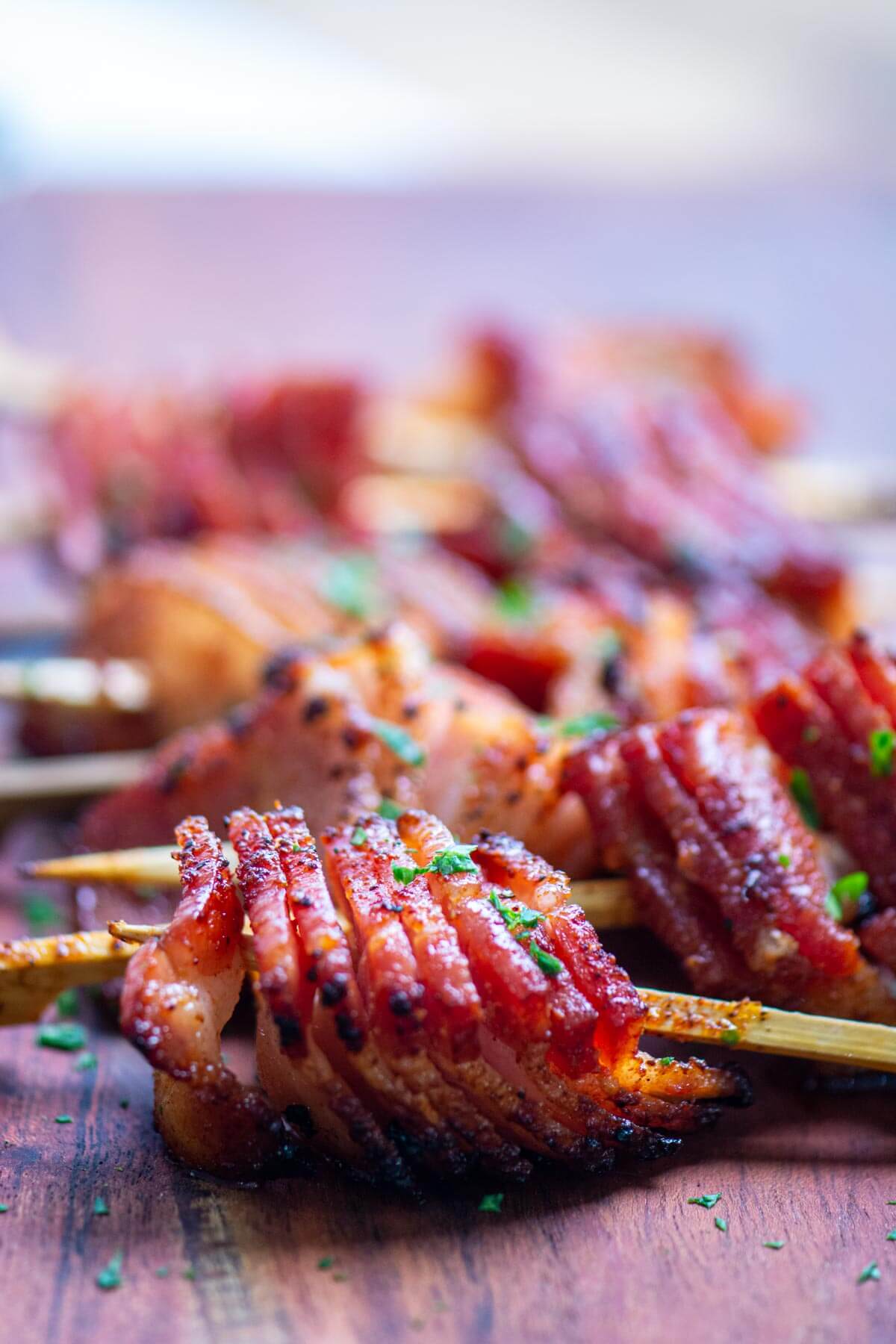 grilled bacon skewers on a cutting board and ready to be served.
