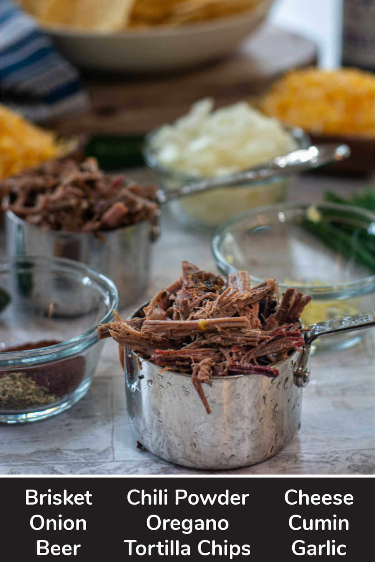 ingredient photo showing measuring cups with brisket, cheese, onion, and seasonings.