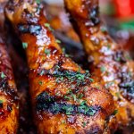 grilled chicken drumsticks standing on a sheet pan showing the great grill marks.