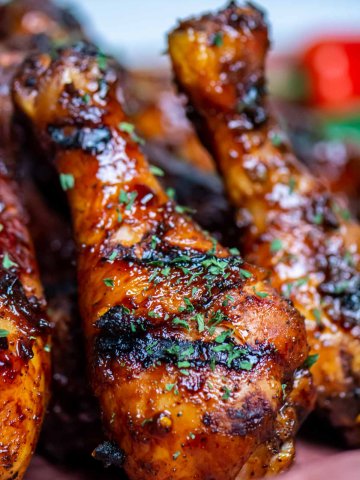 grilled chicken drumsticks standing on a sheet pan showing the great grill marks.