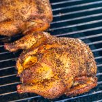 two Cornish hens on the Big Green Egg grill grate after smoking.