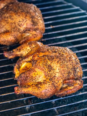 two Cornish hens on the Big Green Egg grill grate after smoking.