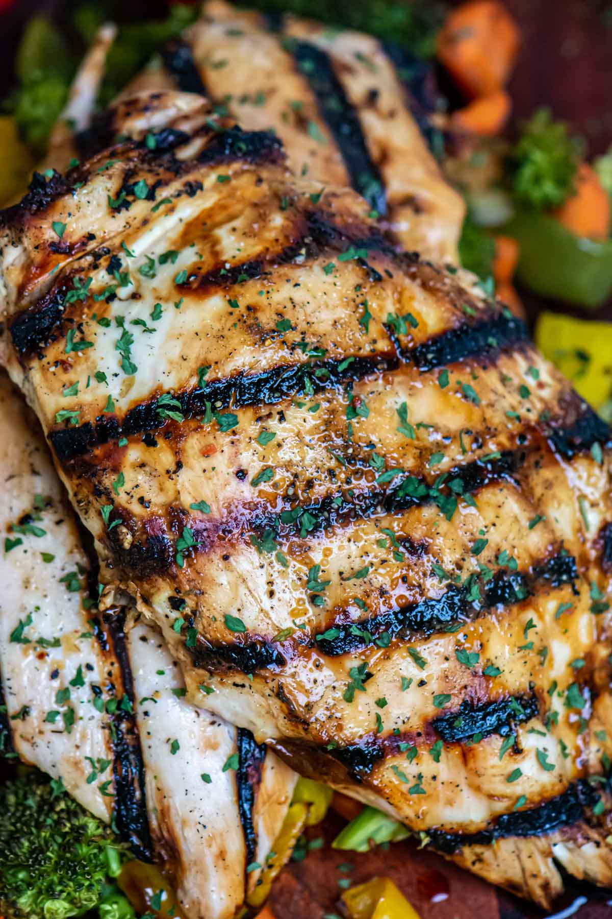 two grilled boneless chicken breasts having been marinated in a honey and orange mixture.