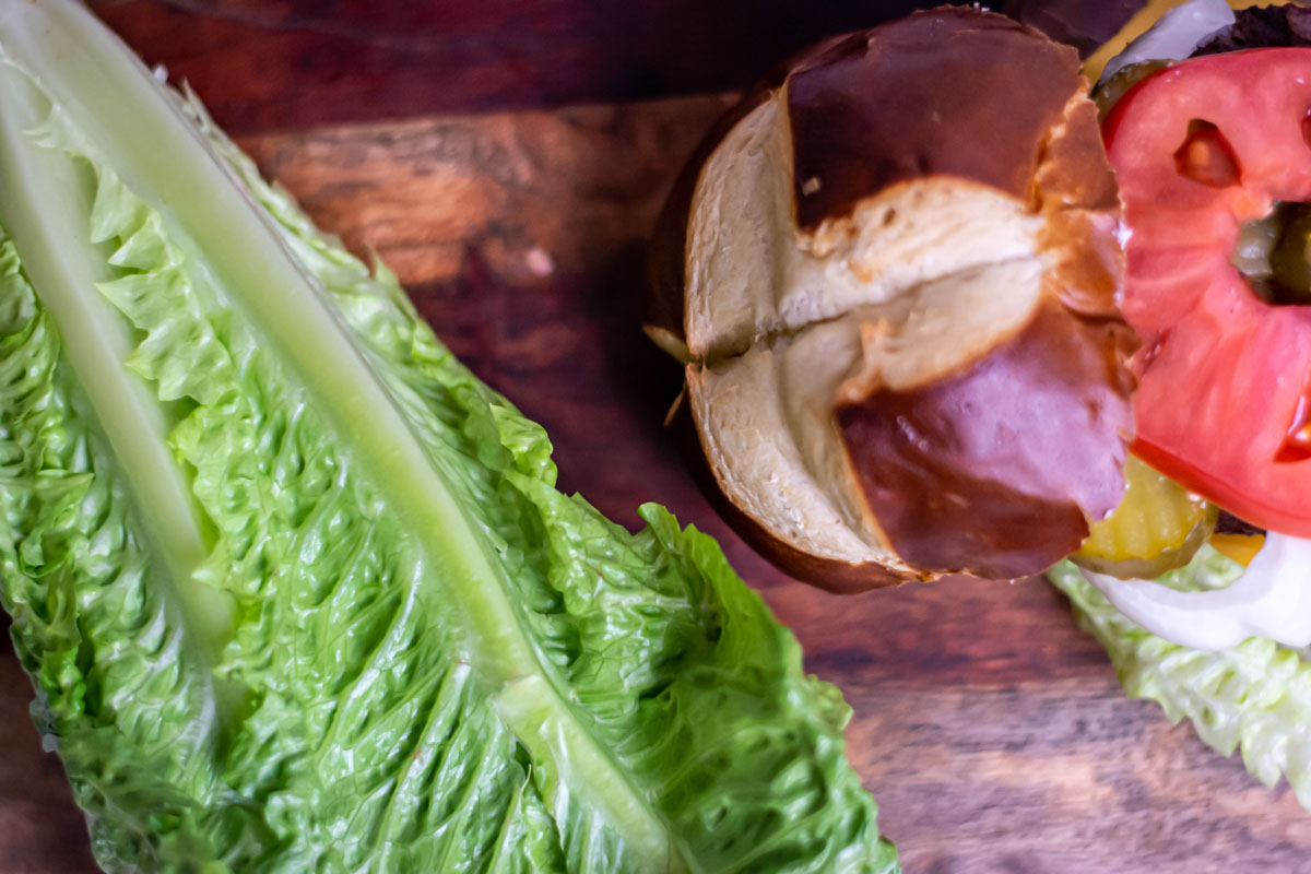 head of romaine lettuce with a hamburger bun.