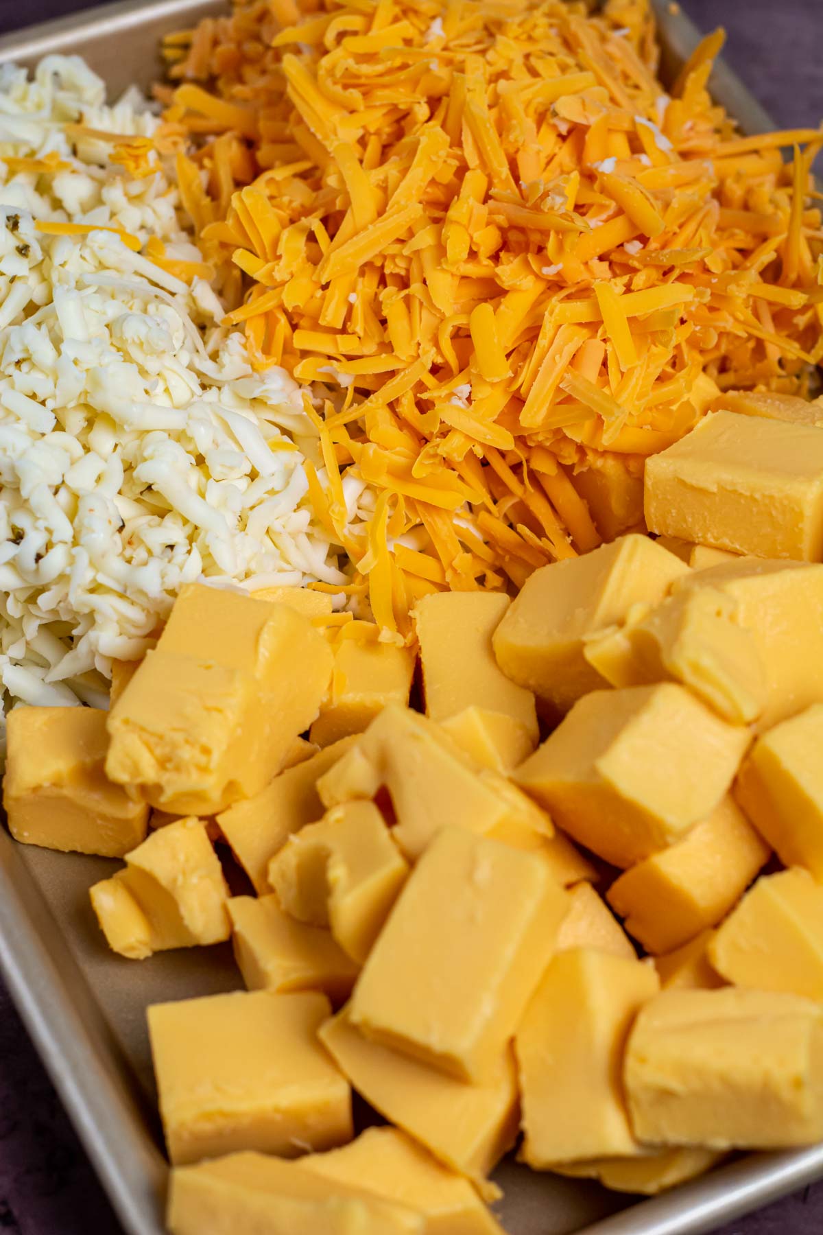 Cubed and shredded cheeses for the queso dip.