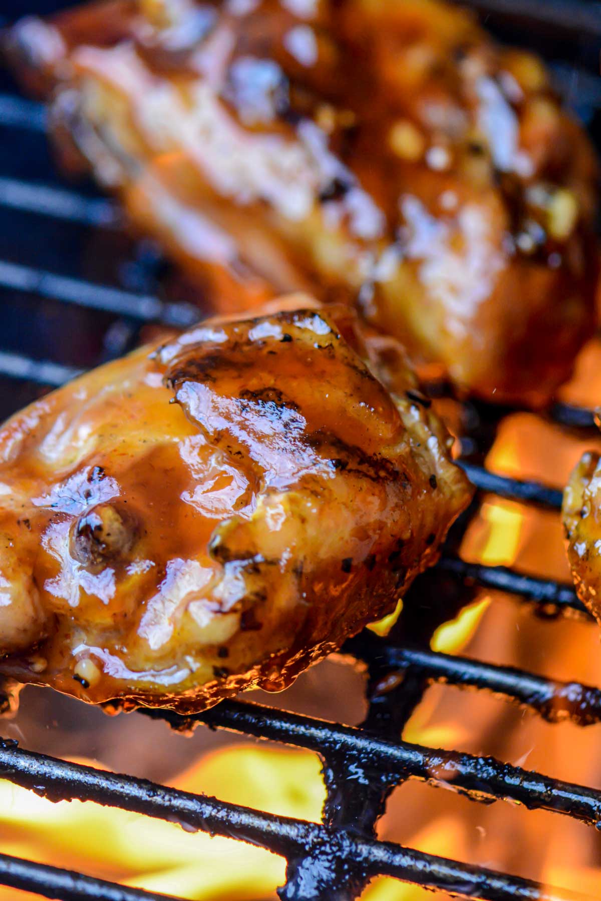 chicken thighs with the sauce brushed on over the flames in the grill.