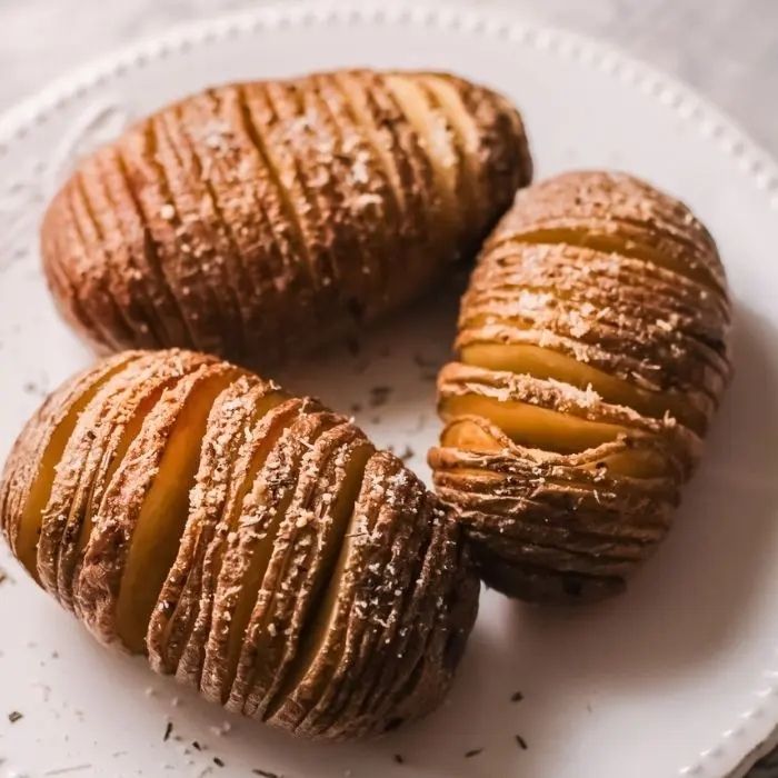 air fried Hasselback potatoes on a white plate.