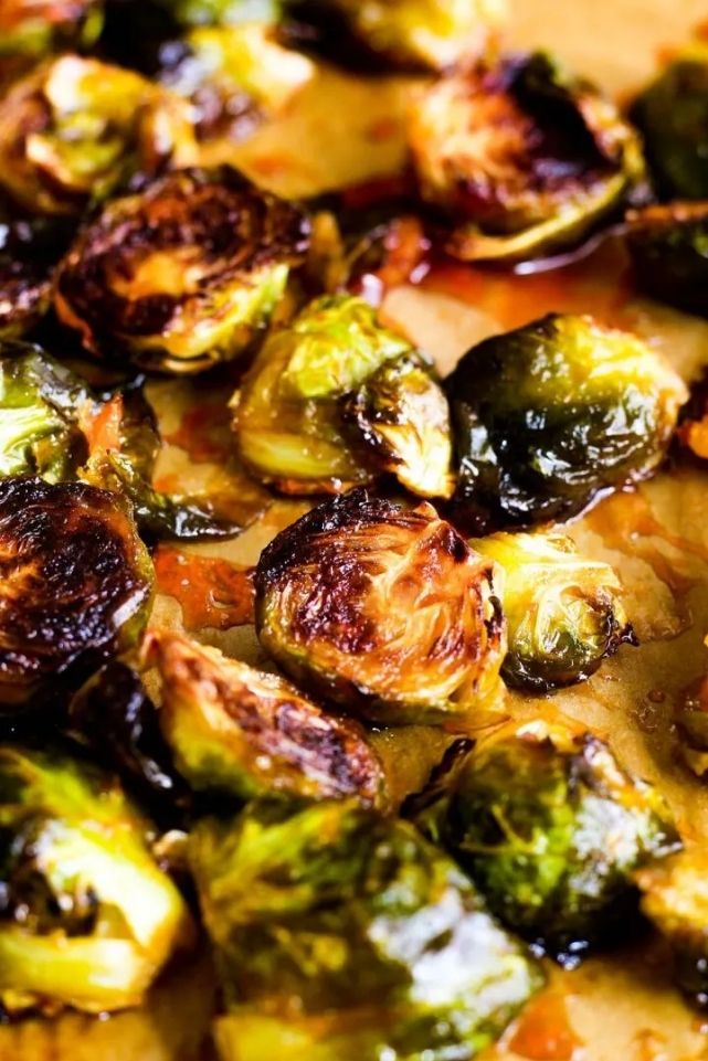 glazed brussel sprouts in a skillet with a honey and sriracha sauce.