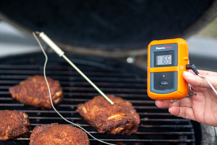 measuring the temperature of the chicken thighs