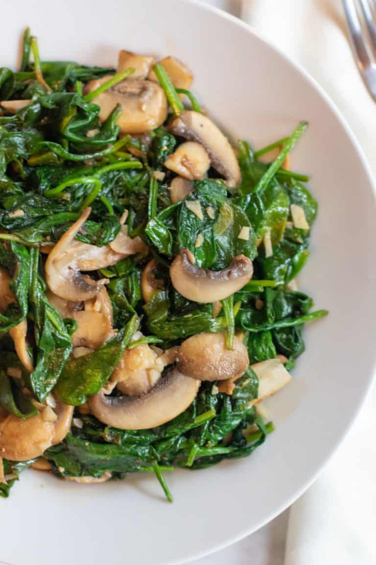bowl of sautéed spinach and mushrooms.