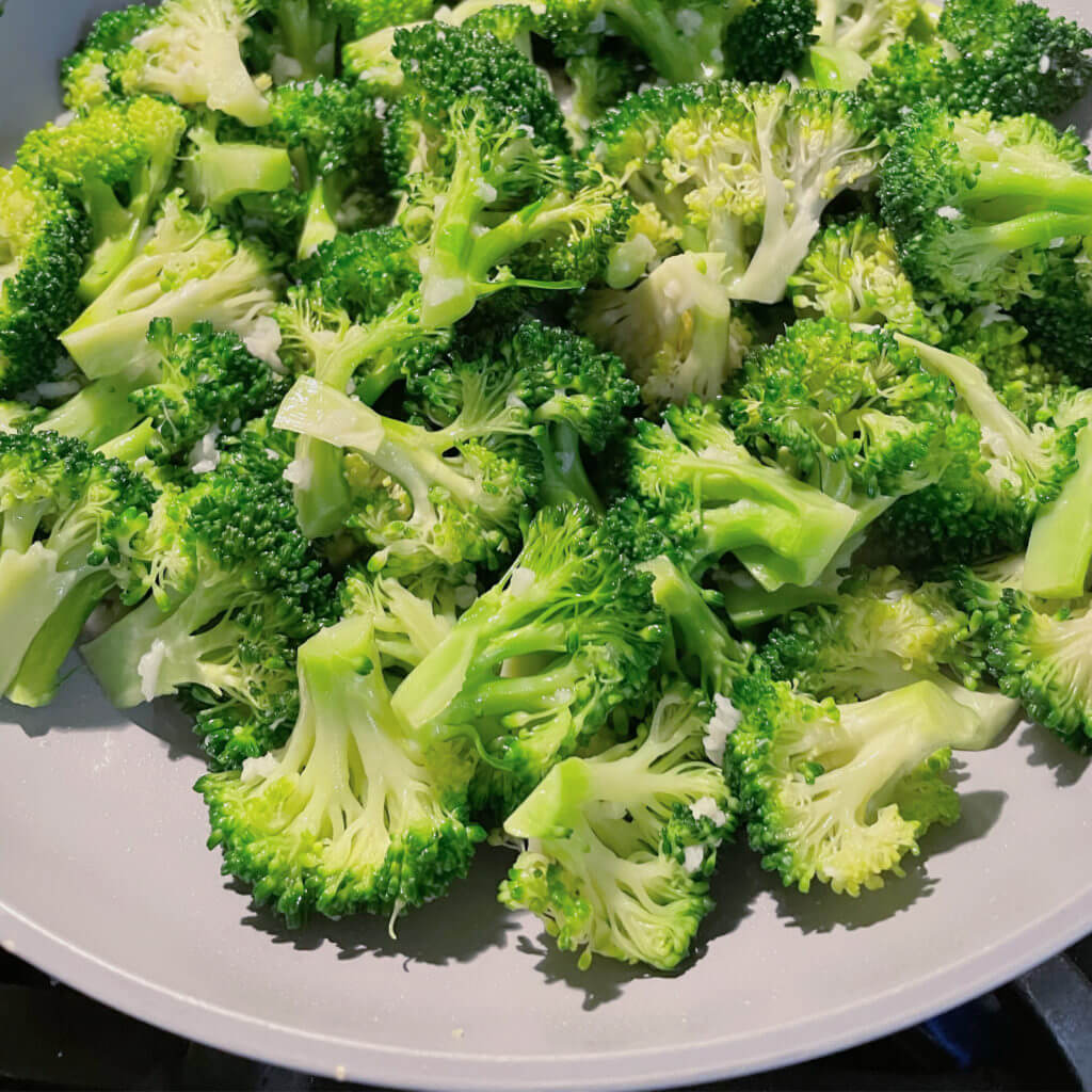 roasted broccoli on a plate with garlic.