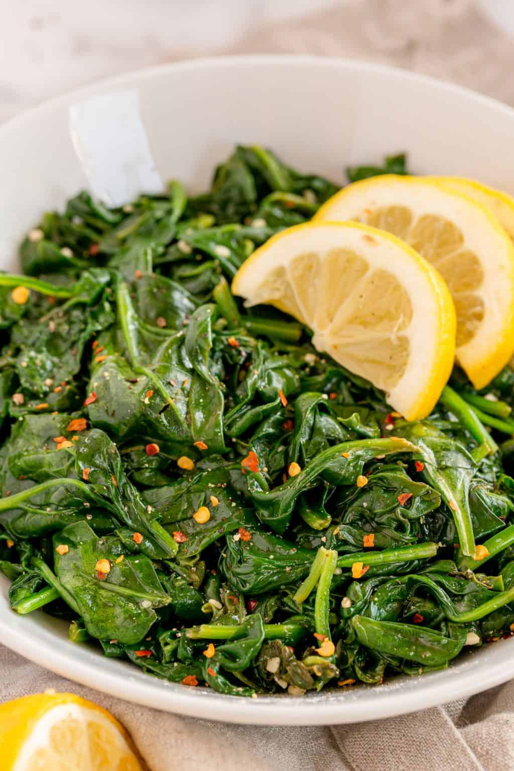 bowl of sautéed spinach with red pepper flakes to add a bit of heat.