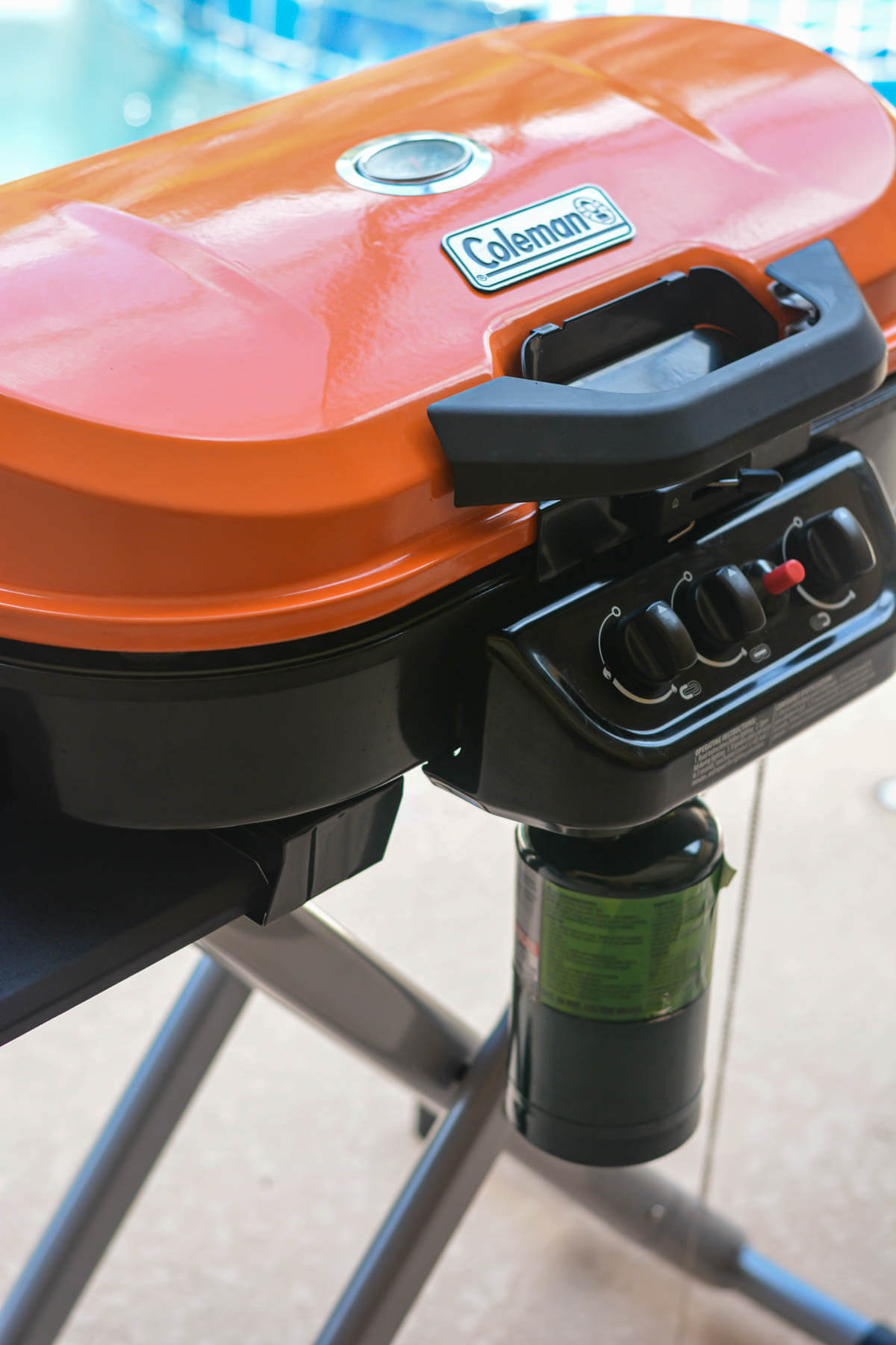coleman grill with a small propane bottle.