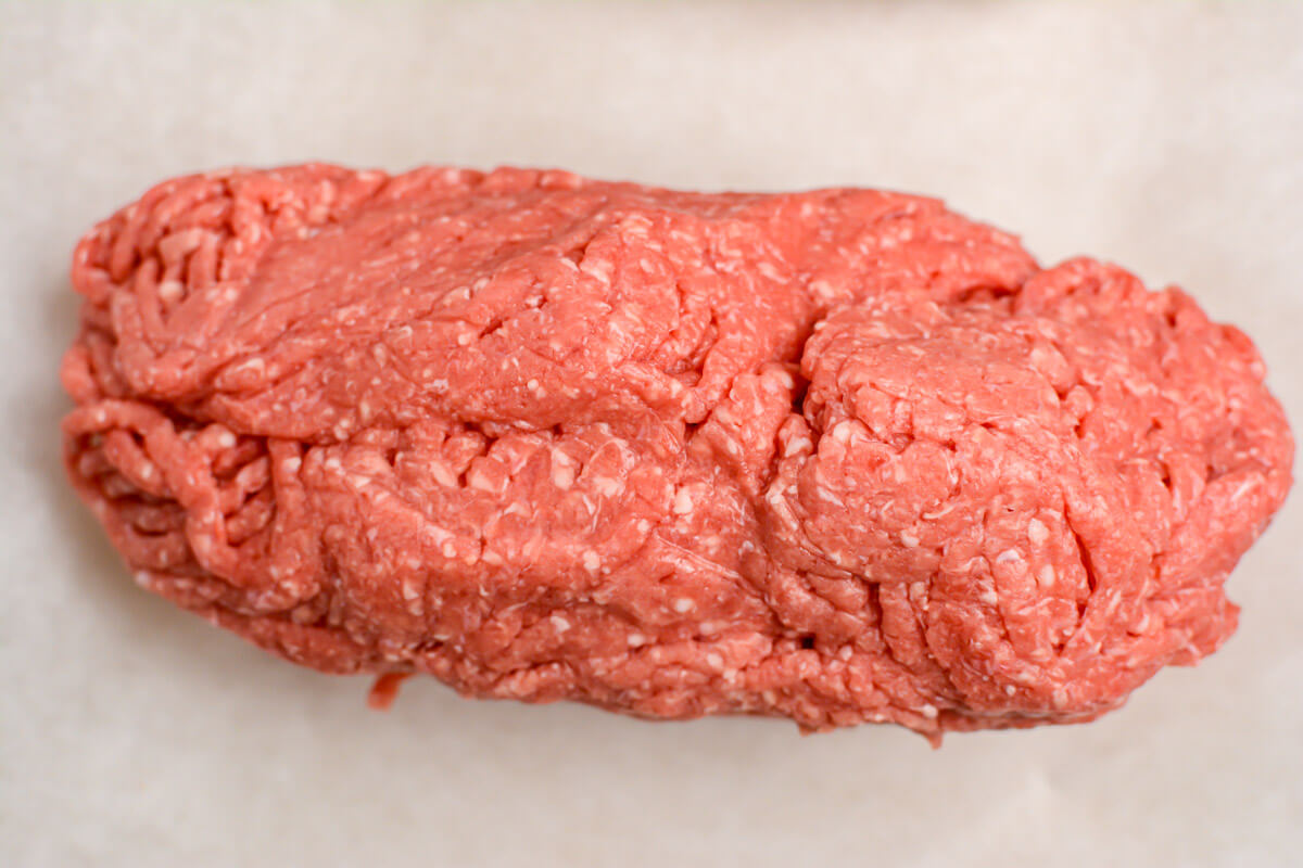 top down view of ground beef on a sheet pan.