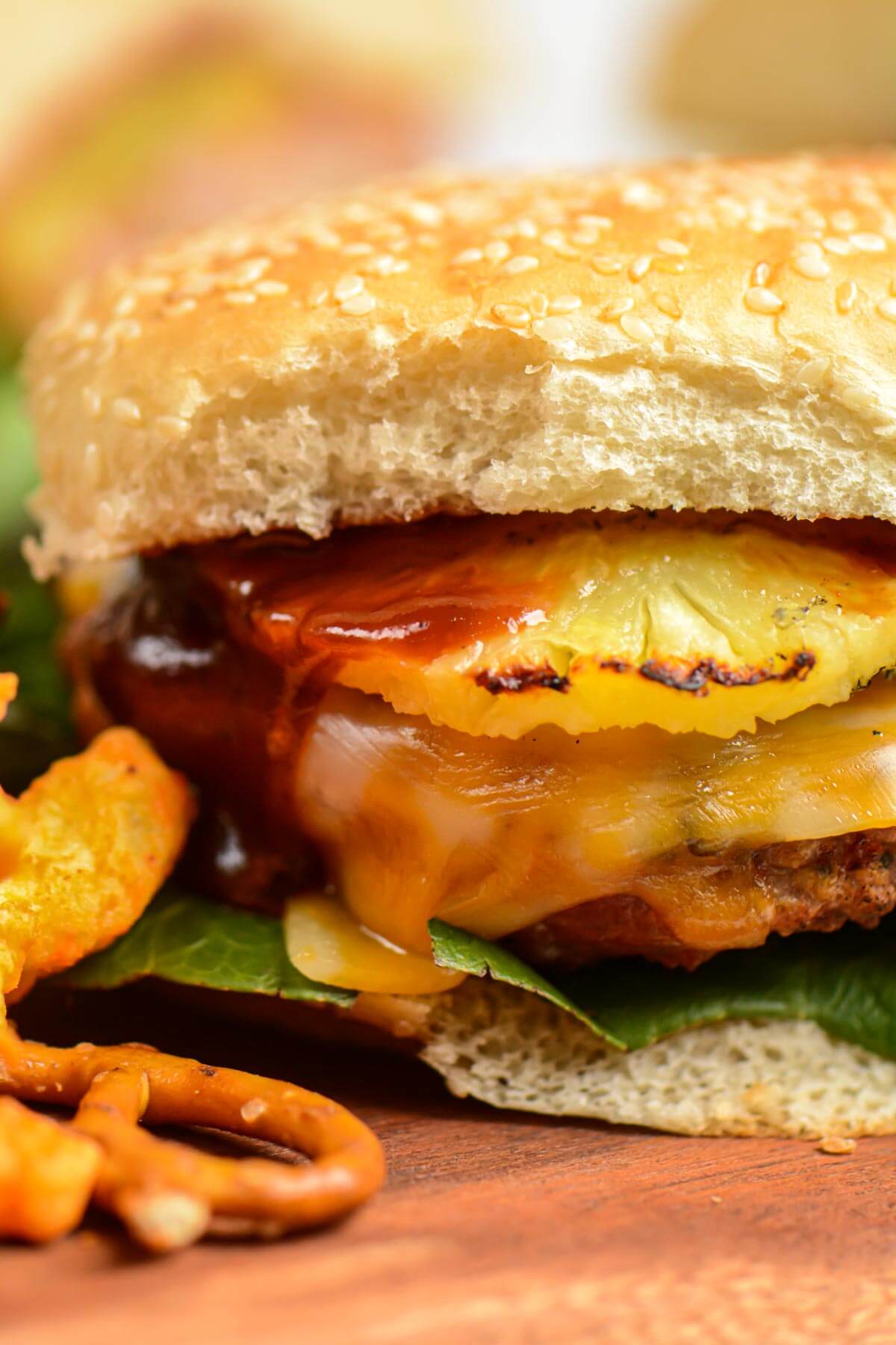 front view of the grilled turkey burger with pineapple, cheese and BBQ sauce showing.