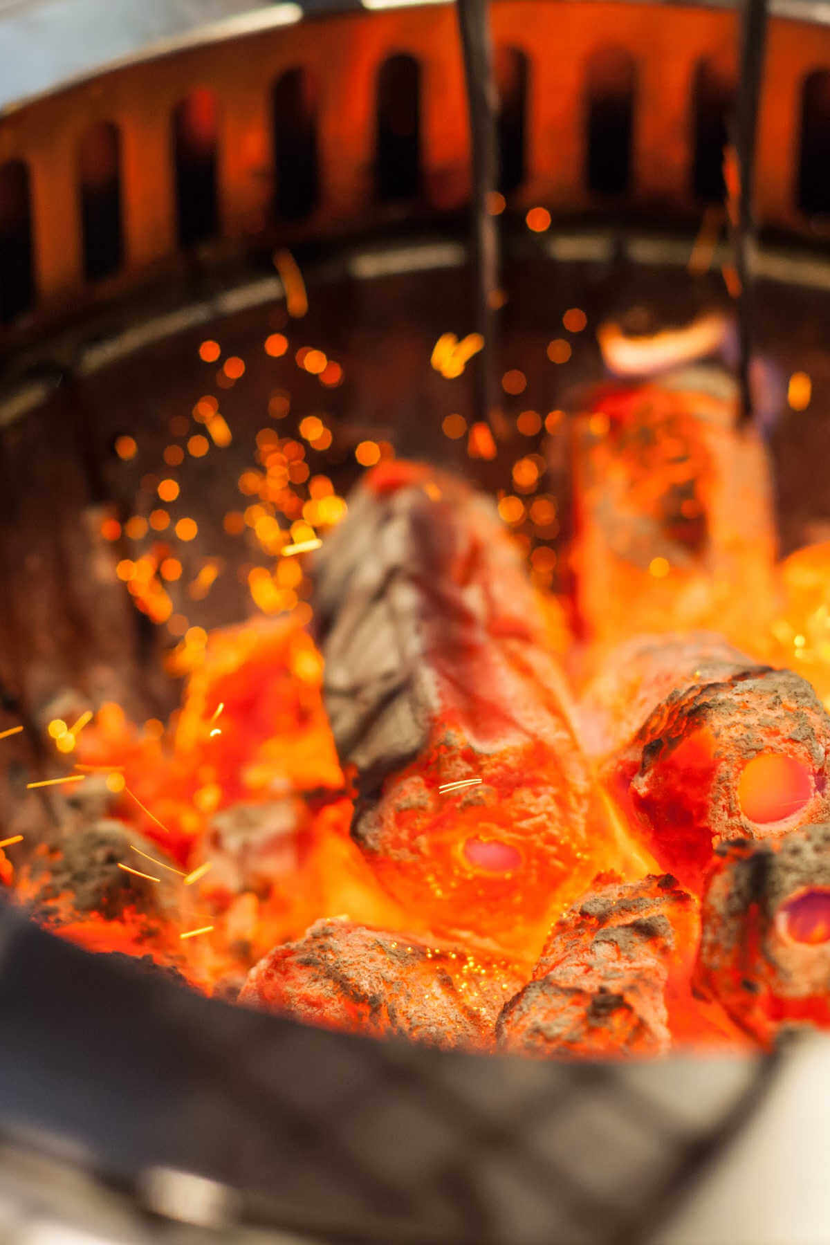 inside a grill with hot, burning lump charcoal.