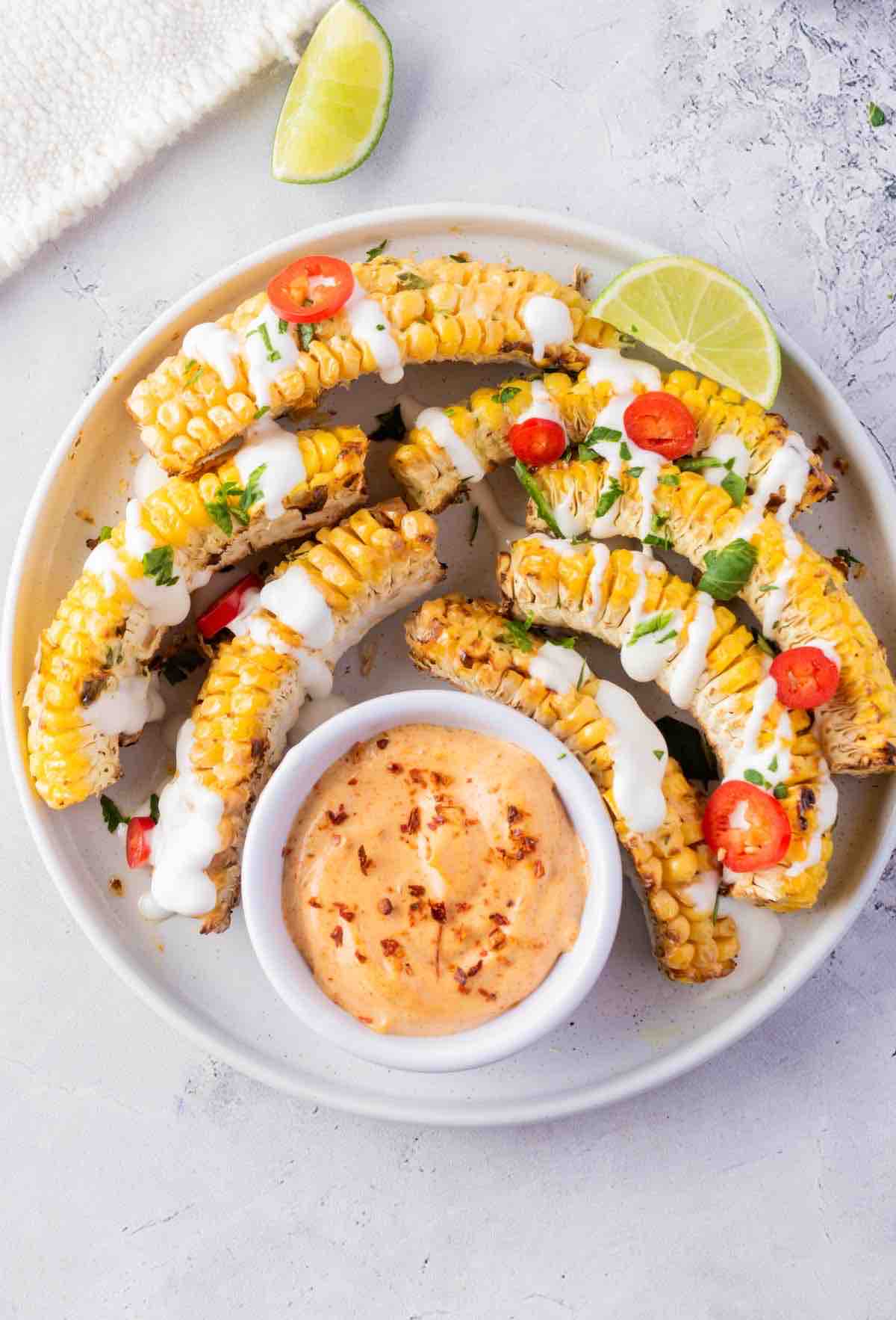 corn sliced and put on a plate with cream and sauce.