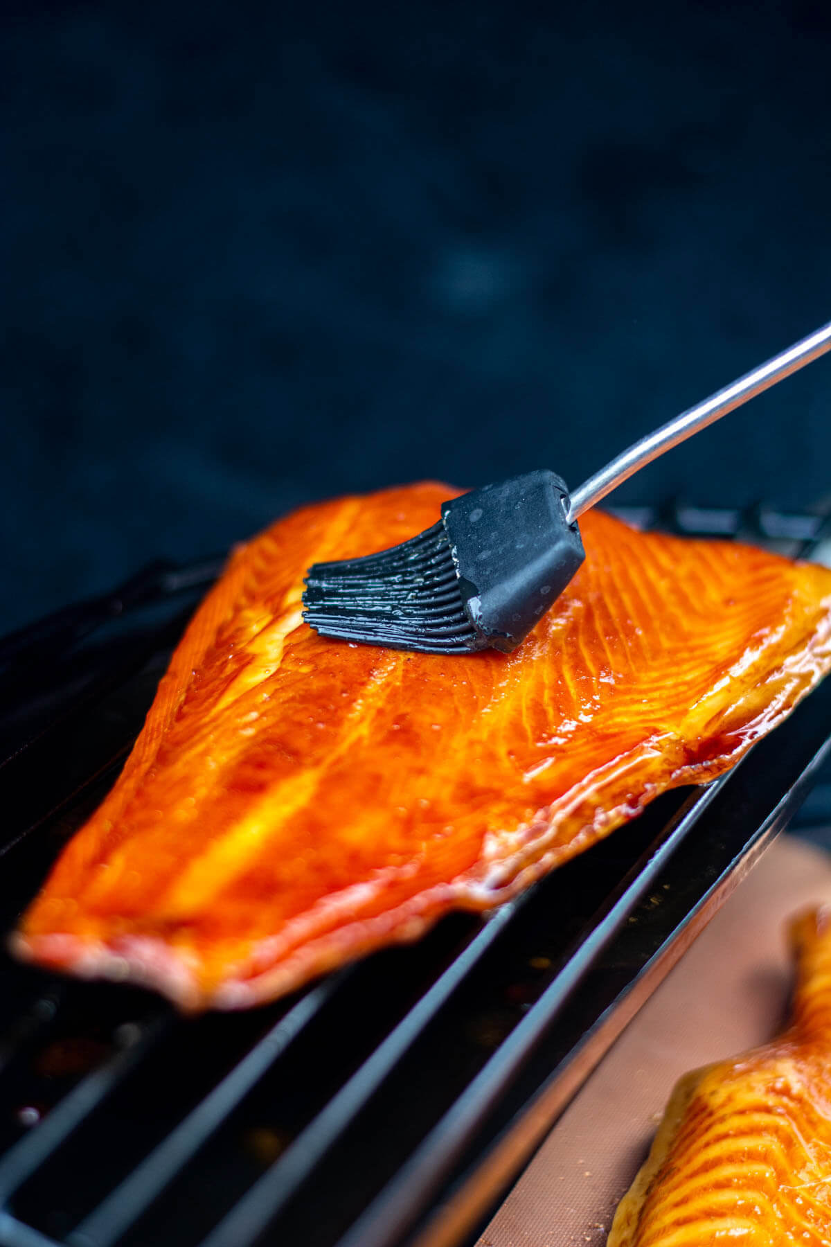Smoked salmon basted on the grill.