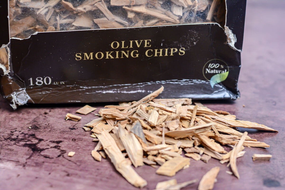 olive wood smoking chips on a table with the box they came in with labels.