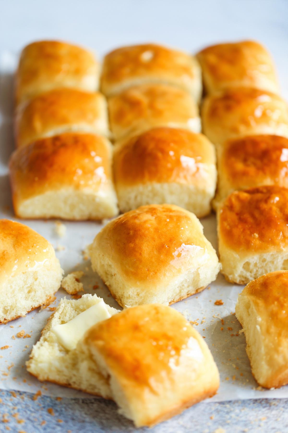 Fresh yeast rolls on parchment paper.