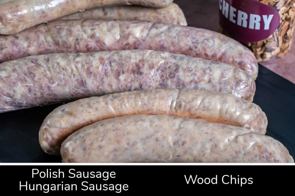 ingredient photo showing hungarian and polish sausages with wood chips and labels.