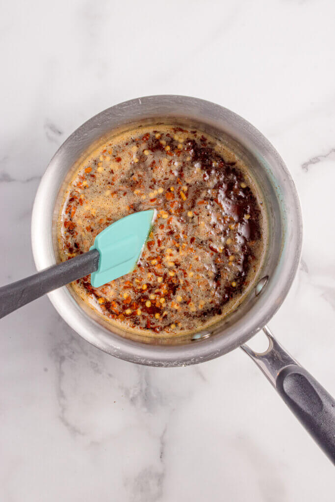 Gently stirring the hot honey as bubbles start to form.