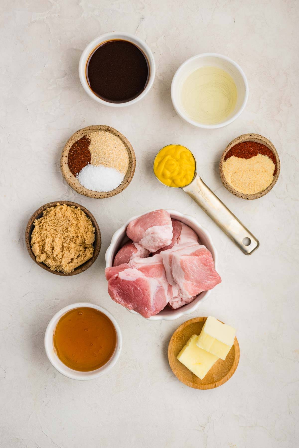top down photo showing the ingredients needed including pork belly, mustard, brown sugar, butter and other seasonings.